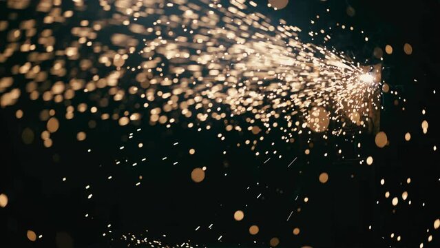 Slow motion: laser cutting, working with a metal workpiece with sparks in a factory. Metalworking, machining, industry, equipment, technology, production concept