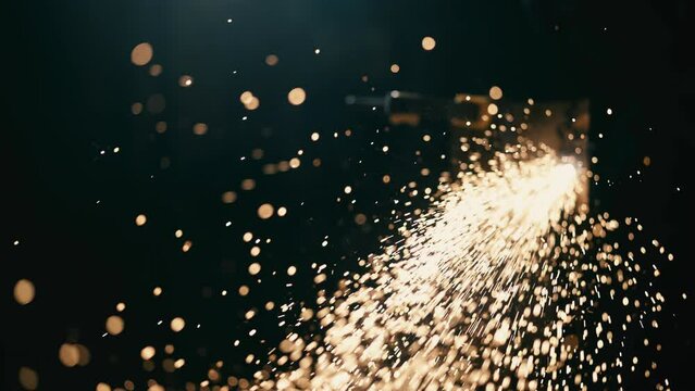 Slow motion: laser cutting, working with a metal workpiece with sparks in a factory. Metalworking, machining, industry, equipment, technology, production concept