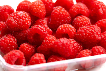 close up fresh raspberries on white background