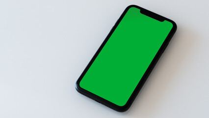 A Green Screen Smartphone on a White Table