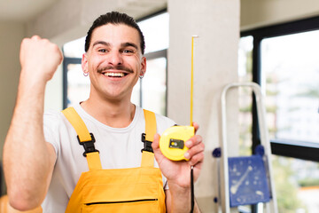 young handsome man handyman or housekeeper concept at home interior
