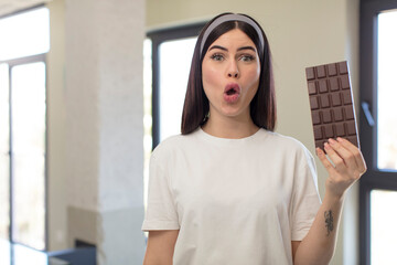 pretty young woman feeling extremely shocked and surprised. chocolate concept