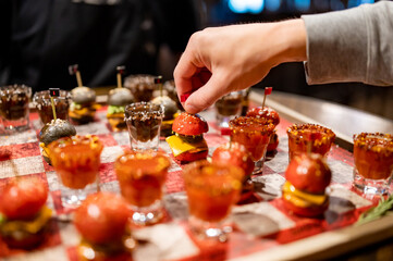 Drunken checkers. men play checkers with shot alcoholic drinks and mini burgers