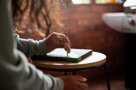 Close-up of a young Aboriginal woman painting