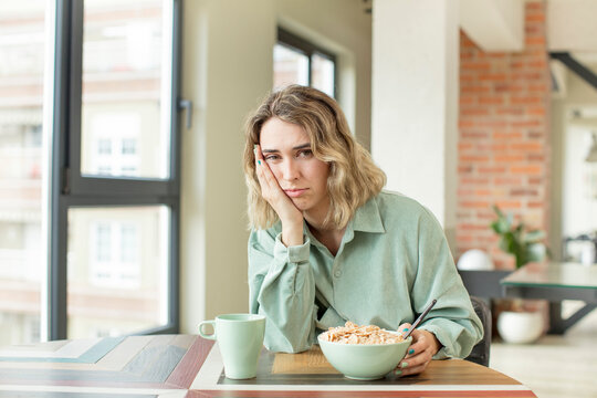 pretty woman feeling bored, frustrated and sleepy after a tiresome. breakfast bowl concept