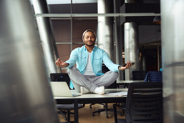 Man relaxing on table at work in the office