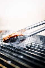 Chef preparing burger at the grill on kitchen