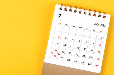 A July 2023 Monthly desk calendar for 2023 year on yellow background.