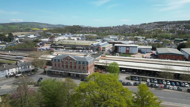 Circling Newton Abbot train station showing wider town, Devon UK