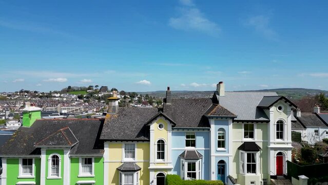 Ascending over row of houses to reveal Newton Abbot