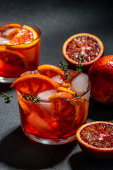 Red cocktail with bloody oranges with ice cubes. Summer refreshing cocktail