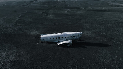 Abandoned wreck of US Navy Douglas DC-3 in Solheimasandur in south part of Iceland. Aerial view of one of the most visited location by tourist. Beach at Sólheimasandur, in the South Coast of Iceland.