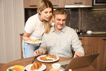 Happy couple spending time in the kitchen in hotel room