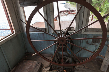Wheelhouse of an abandoned barge. Empty captains bridge © evannovostro