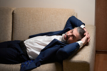 Close up photo of male resting on sofa