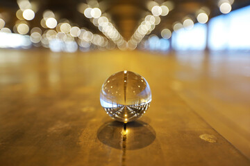 A lens ball on the floor nighttime scene in low light, shallow dept of field and selective focus.