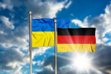 ukraine and flag of germany on beautiful blue sky background