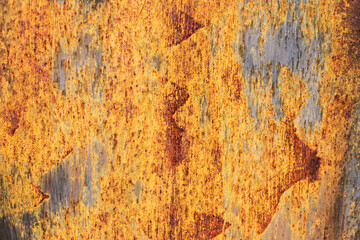Orande rusty abstract painted metal background. texture of old plate with brown rust