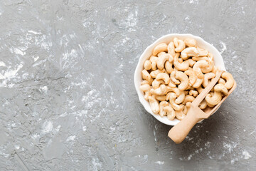 cashew nuts in wooden bowl on table background. top view. Space for text Healthy food