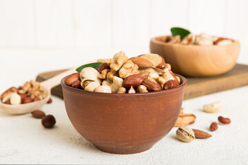 mixed nuts in bowl. Mix of various nuts on colored background. pistachios, cashews, walnuts, hazelnuts, peanuts and brazil nuts