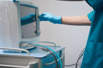 Medical worker works with an ultrasound machine in diagnostic center