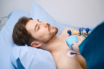 Cardiograph suction cups are attached to patient to take cardiogram