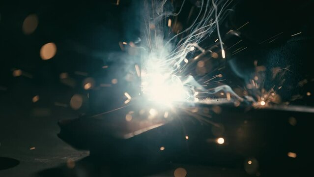 Closeup of a welding machine in work. Worker welds metal.
