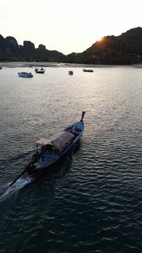 Aerial video of a boat sailing on the shores of Koh Phi Phi Thailand 