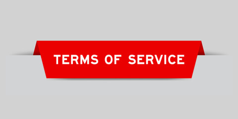 Red color inserted label with word terms of service on gray background