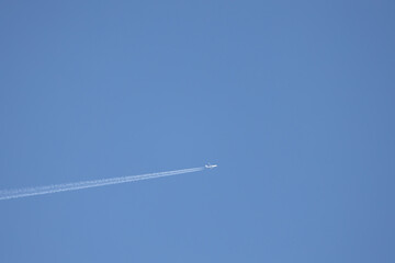 plane in the sky leaving its wake