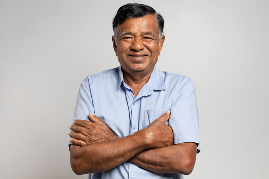 Portrait Asian elderly man. Smiling old man with arms crossed looking at camera isolated on white background
