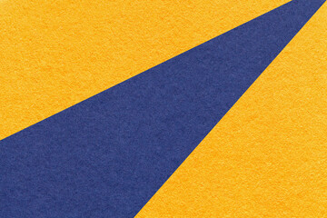Texture of old craft yellow and navy blue color paper background, macro. Vintage abstract orange cardboard