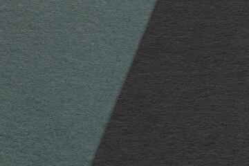 Texture of craft dark green and black paper background, half two colors, macro. Vintage dense kraft olive cardboard.