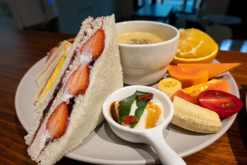 breakfast on the wooden with strawberry sandwich