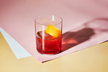 Cold alcoholic or non-alcoholic cocktail on pastel background. Hard light, deep shadow.