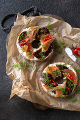 bagels with beetroot and salmon on a wooden board