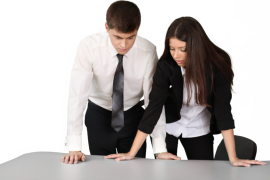 Businessman and Businesswoman Standing Behind Table and Talking - Isolated