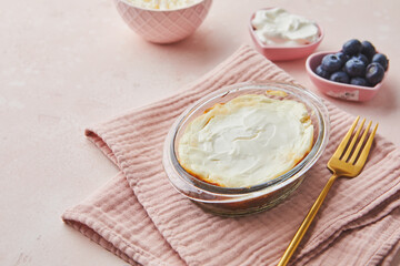 Delicious cottage cheese casserole in portioned glass forms with sour cream. Traditional Russian cuisine for breakfast - Zapekanka.