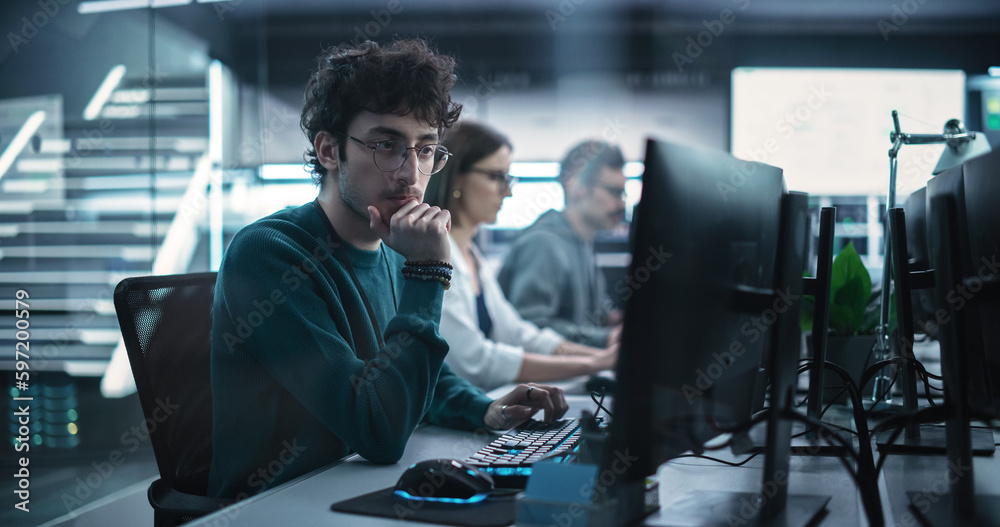 Poster Young Handsome Software Developer Working on Computer in a Technological Laboratory Environment. IT Programming Department Tirelessly Researching and Developing Advanced Commercial Internet Products