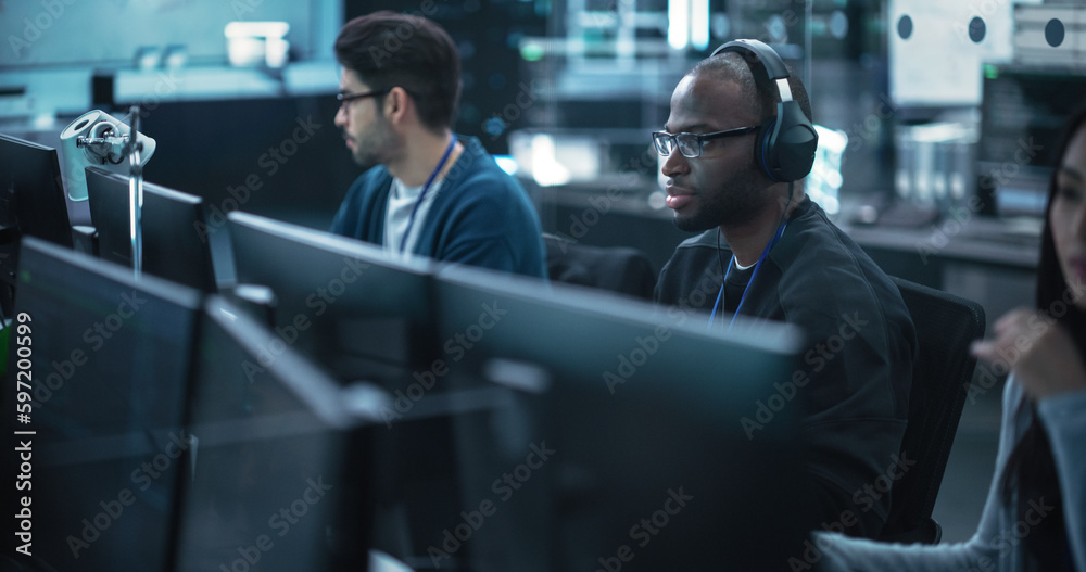 Fototapete African American Computer Engineer Finds and Fixes Bugs in a Product or Program Before the Launch. Young Black Specialist Working in Advanced Technology Industry
