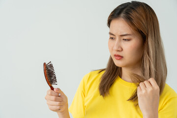 Asian woman very sad and upset looking at damaged hair, hair loss, hair thinning problem, vitamin...