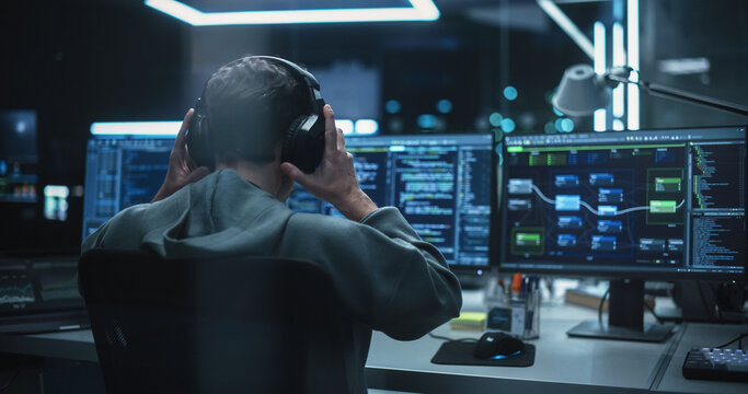 Young Hacker Working Alone, Hacking Corporate Data Servers From His Underground Hideout. Hacktivist Organizes a Massive Data Breach Cyber Attack, Hiding His Identity Behind Multiple Proxy Servers