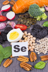 Healthy food containing selenium, fiber and other vitamins and minerals. Black wooden background