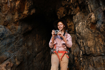 Little girl shoot beautiful view by mirrorless camera during hiking adventure travel in Cave