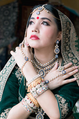 A young woman dressed in Indian ceremonial attire.