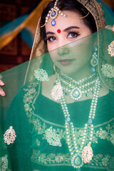 A young woman dressed in Indian ceremonial attire.