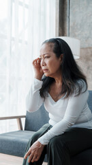 Mature woman feeling sad, asian elderly housewife anxiety depressed thinking senior chinese ethnicity.