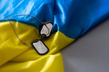 Army identification badges, ribbons of the Ukrainian flag, scattered machine-gun cartridges and...