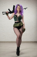 sexy girl with pink hair in a short skirt miliriti with an airsoft gun on a white background of a...