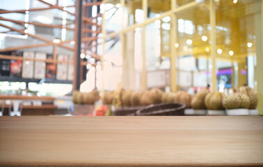 Obraz premium Empty dark wooden table in front of abstract blurred bokeh background of restaurant . can be used for display or montage your products.Mock up for space.